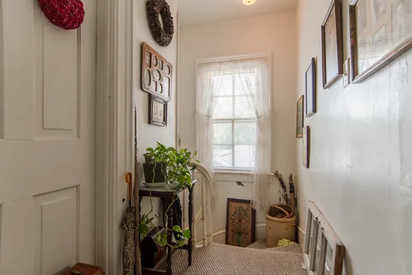 a view of an entryway with wooden floor and front door