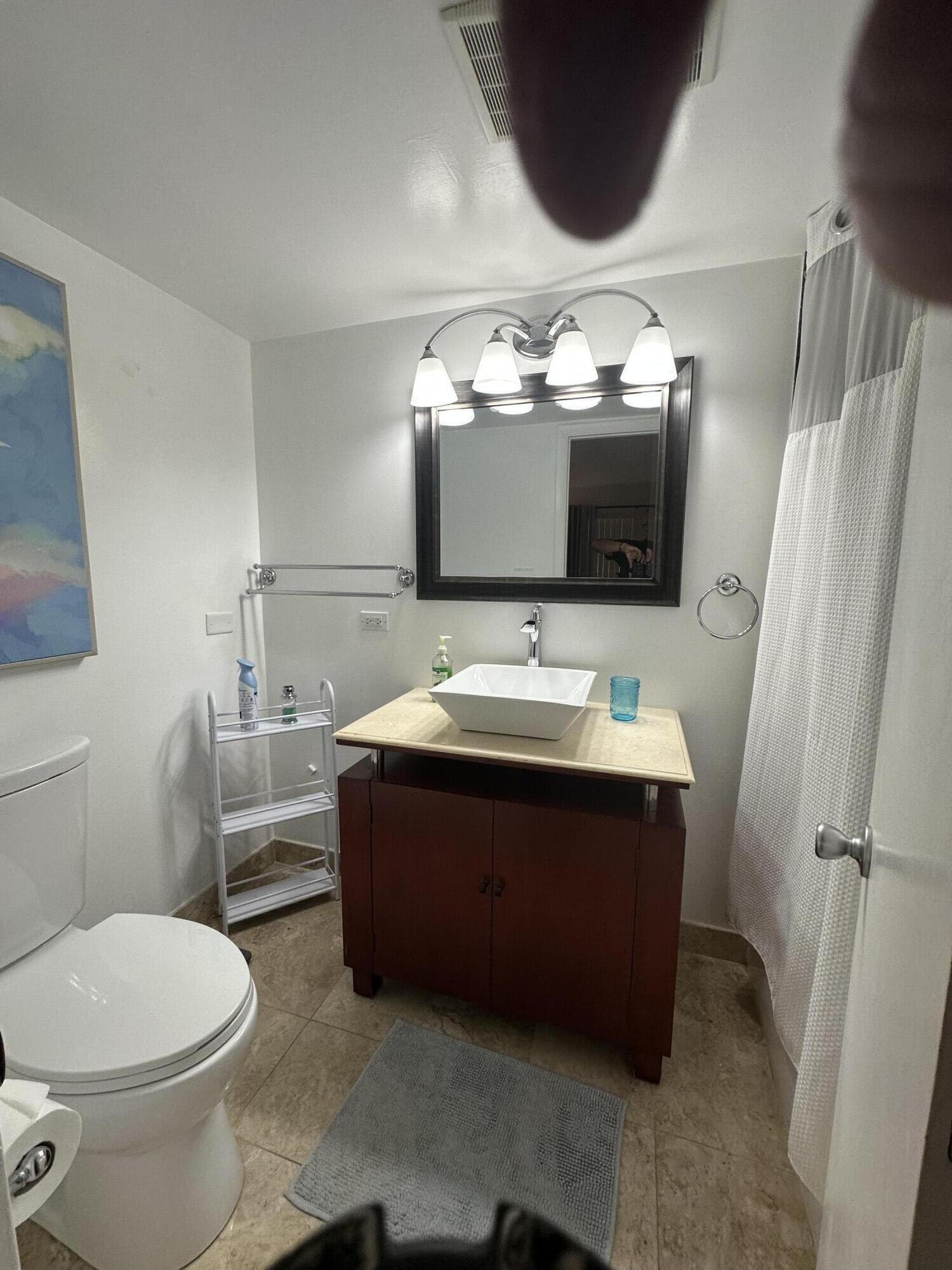 1169 Hillsboro Mile, Unit 109 Hillsboro Beach, FL 33062 - Photo 11 of 18 a bathroom with a sink vanity mirror and toilet