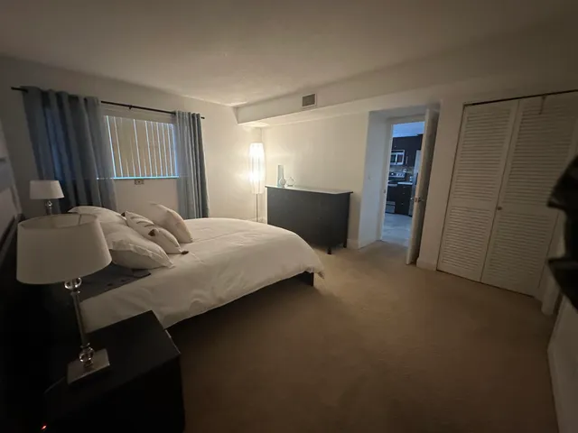 a bedroom with a bed and dresser