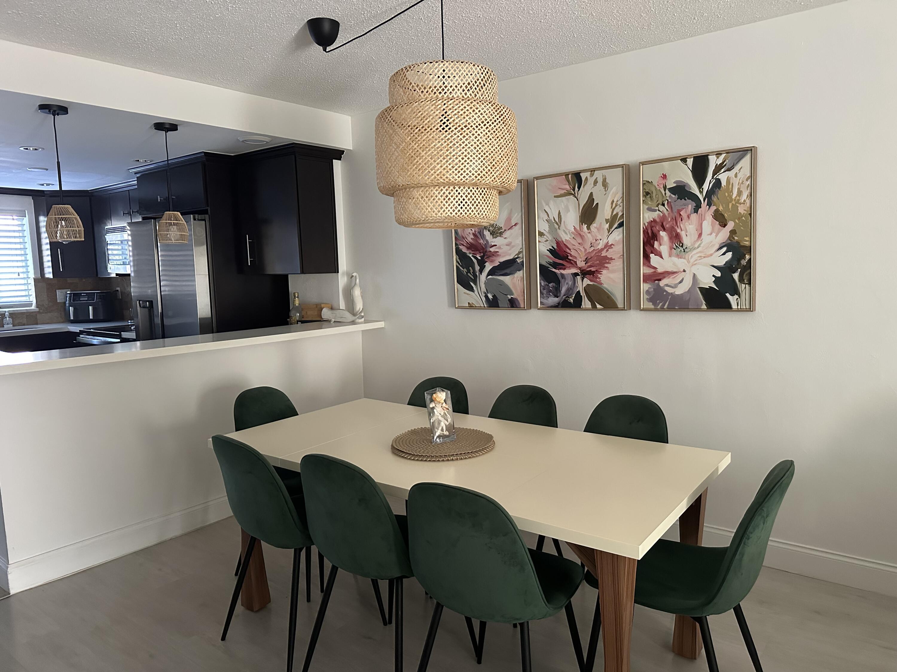 1169 Hillsboro Mile, Unit 109 Hillsboro Beach, FL 33062 - Photo 3 of 18 a view of a dining room with furniture and wooden floor