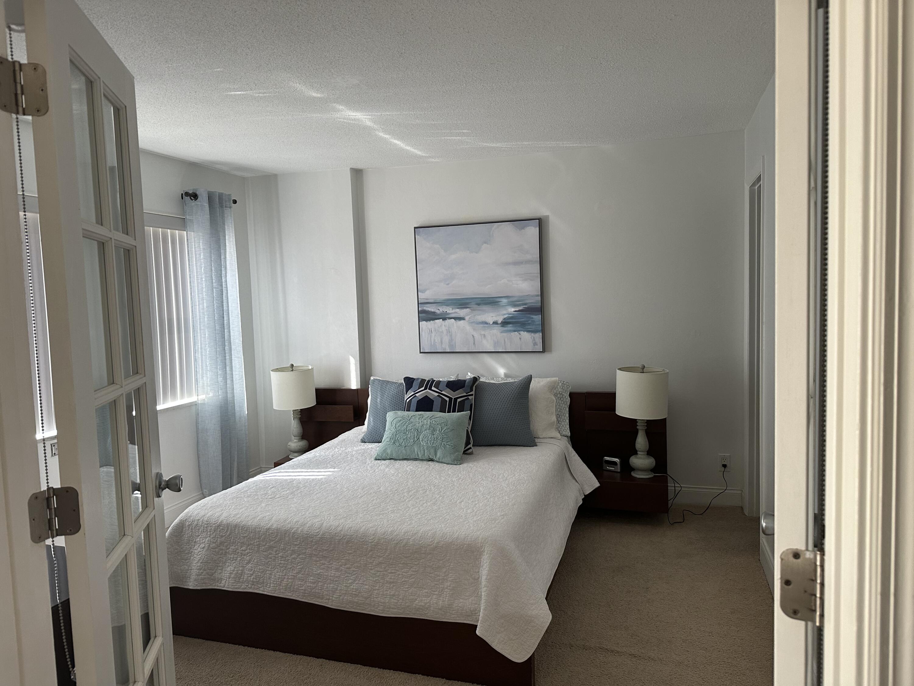 1169 Hillsboro Mile, Unit 109 Hillsboro Beach, FL 33062 - Photo 6 of 18 a bedroom with a bed and a painting on the wall