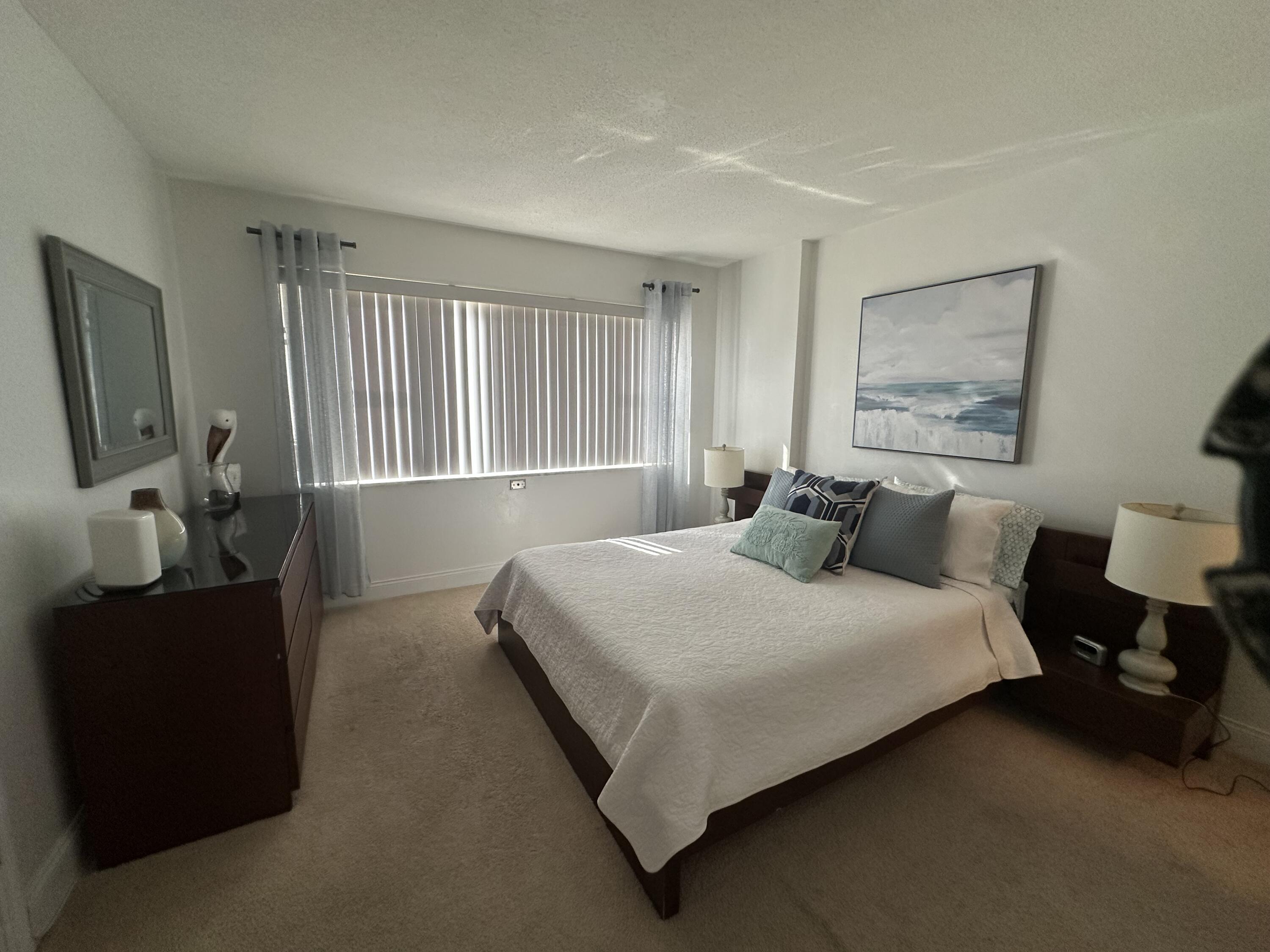 1169 Hillsboro Mile, Unit 109 Hillsboro Beach, FL 33062 - Photo 8 of 18 a bedroom with bed and window