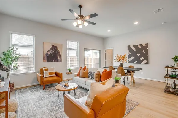 a living room with fireplace furniture and a large window