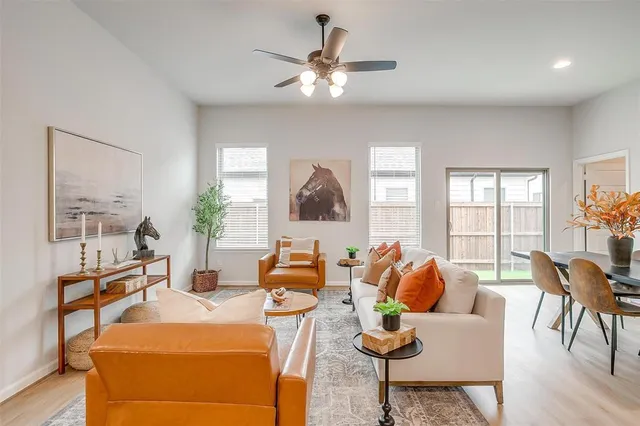 a living room with furniture and wooden floor
