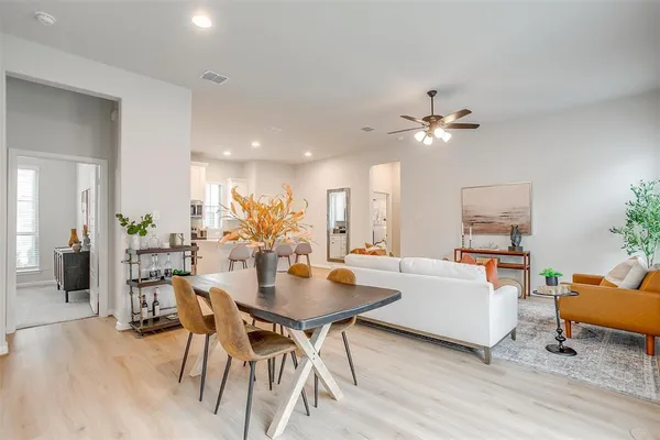 a view of a dining room with furniture and wooden floor