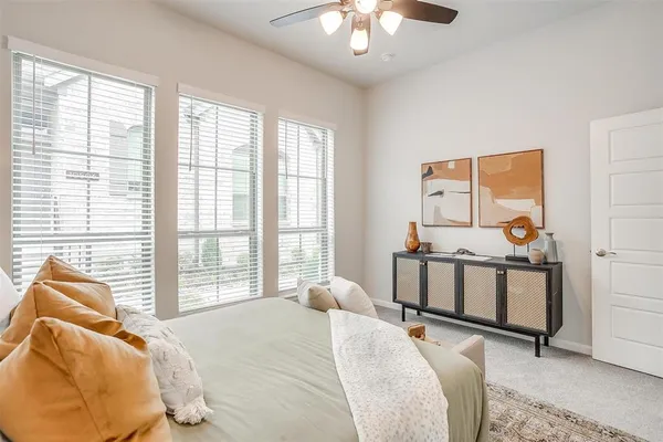 a bedroom with two beds and windows