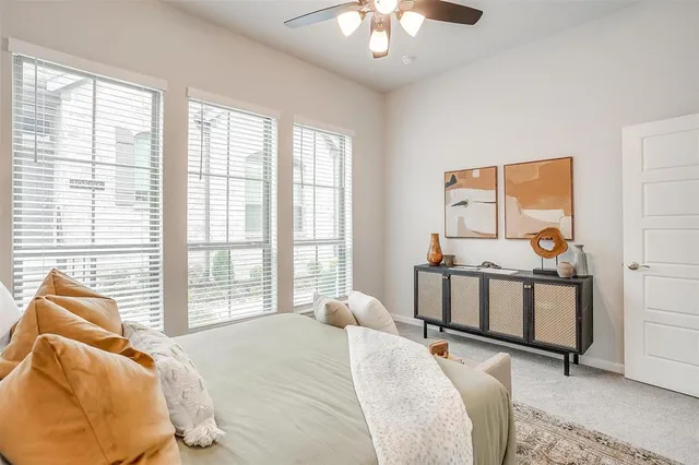a bedroom with two beds and windows