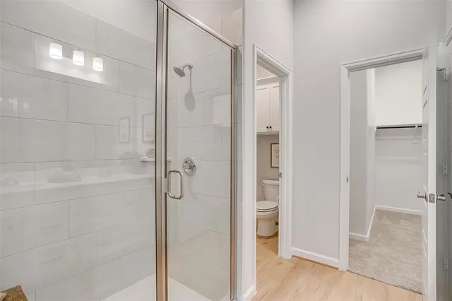 a bathroom with a shower and a glass door