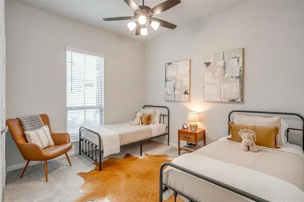 a bedroom with furniture and a large window