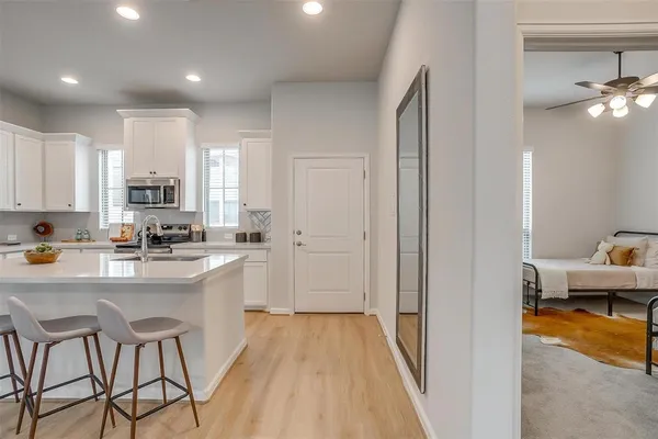 a kitchen with stainless steel appliances granite countertop refrigerator sink and cabinets