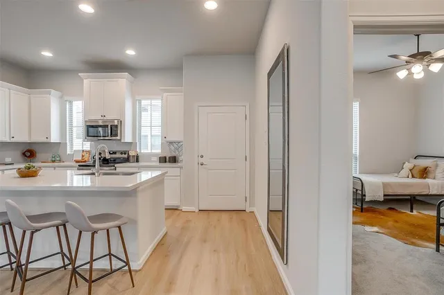 a kitchen with stainless steel appliances granite countertop refrigerator sink and cabinets
