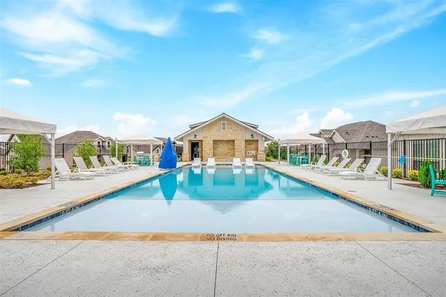 a view of house with outdoor space and sitting area