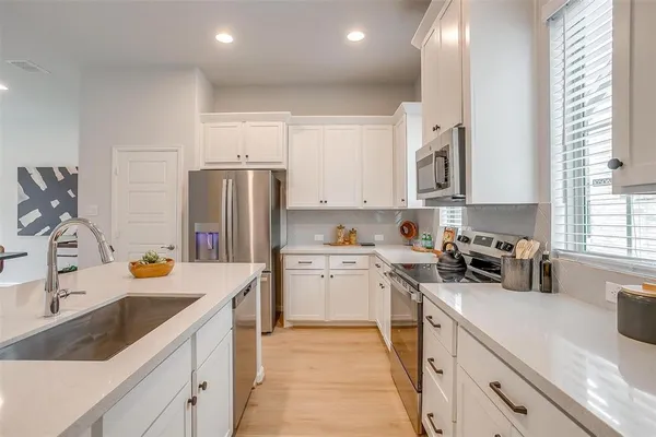a kitchen with a sink stove and refrigerator