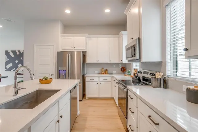 a kitchen with a sink stove and refrigerator