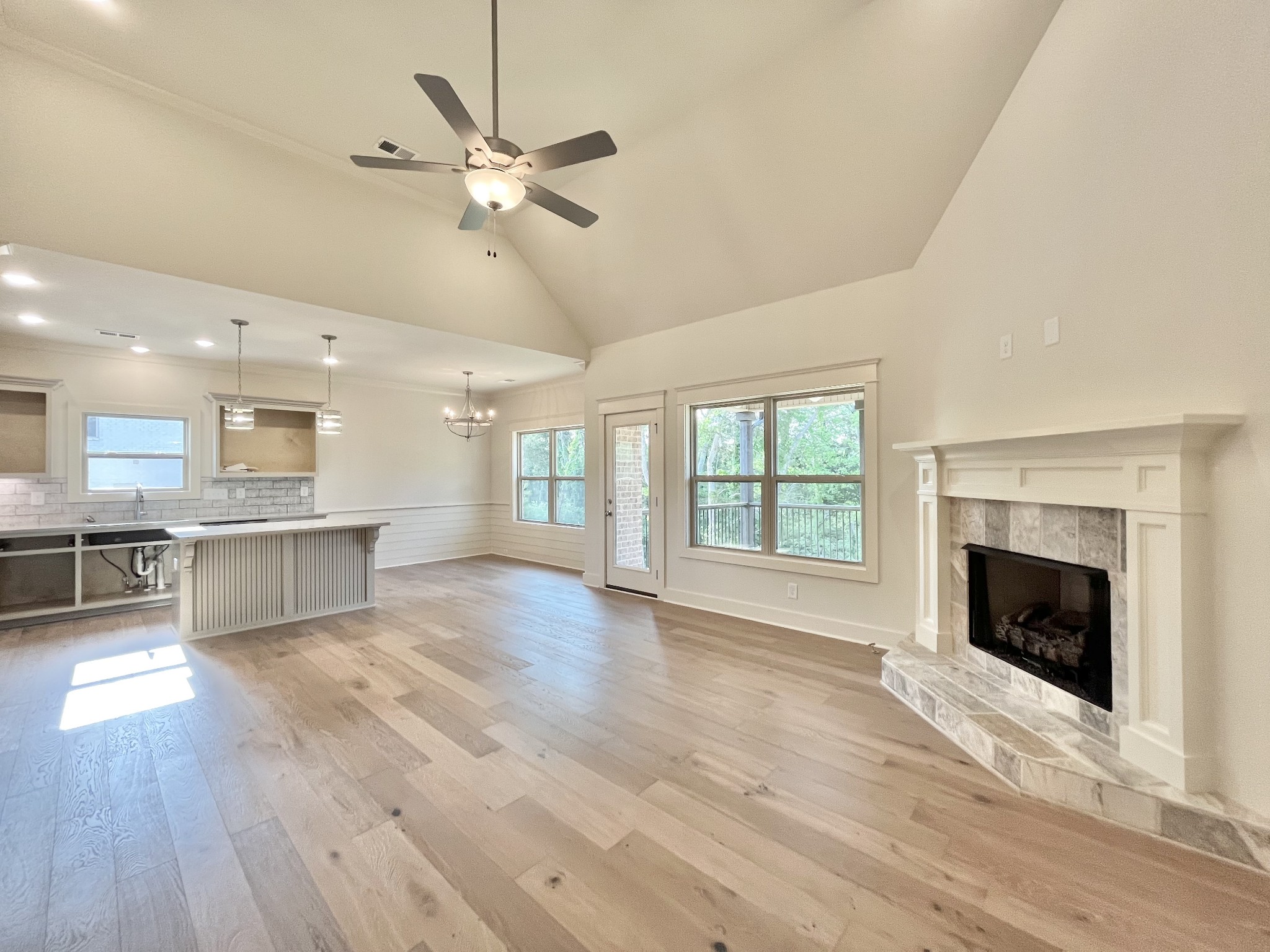 811 Ridgestone Place, Unit 98 Lebanon, TN 37087 - Photo 4 of 21 a view of an empty room with wooden floor and a kitchen