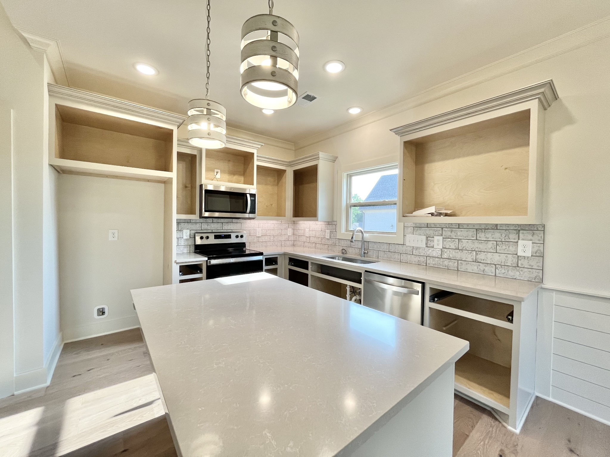 811 Ridgestone Place, Unit 98 Lebanon, TN 37087 - Photo 6 of 21 a kitchen with stainless steel appliances granite countertop a stove top oven a sink dishwasher a refrigerator and a dining table with wooden floor