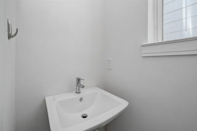a bathroom with a sink and a window