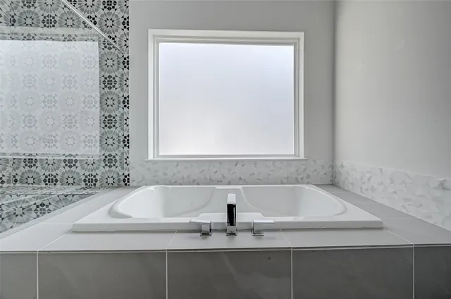 a bathroom with a bathtub and shower