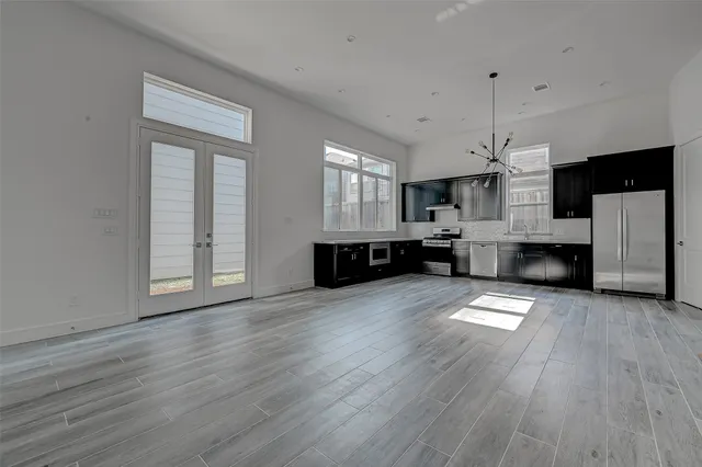 a view of kitchen and hall with wooden floor