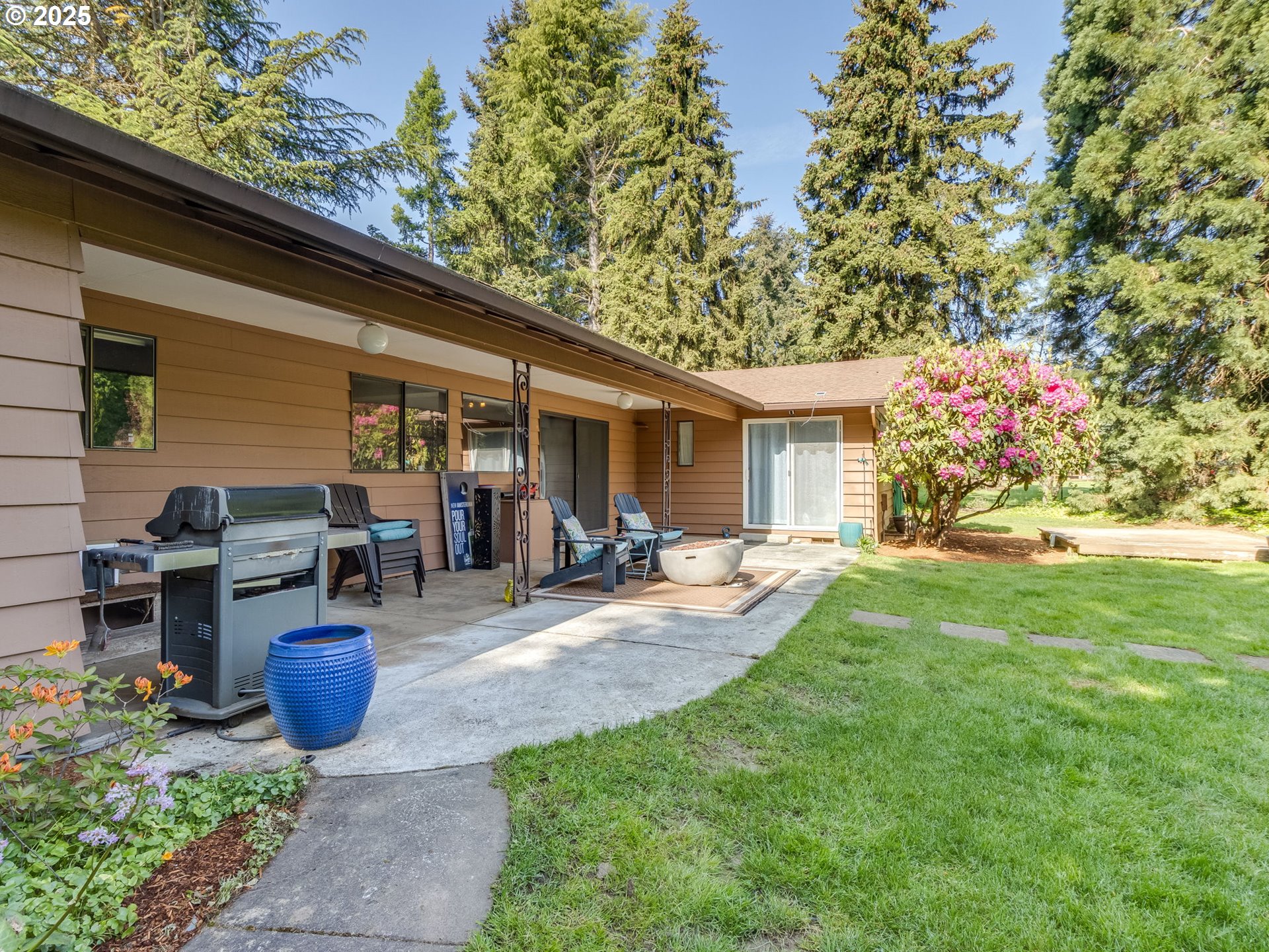 11963 Broadacres Road Northeast Hubbard, OR 97032 - Photo 5 of 42 a view of a backyard with plants and a patio