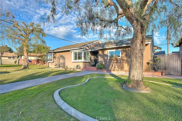 a view of a house with a yard patio and swimming pool