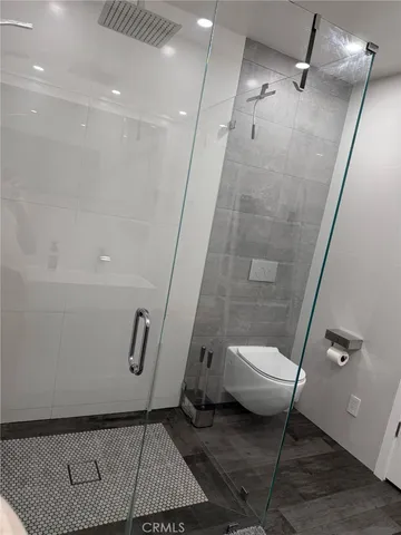 a bathroom with a sink a toilet and a shower