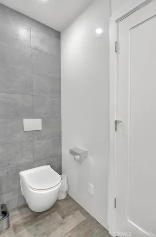 a white toilet sitting next to a bathroom sink