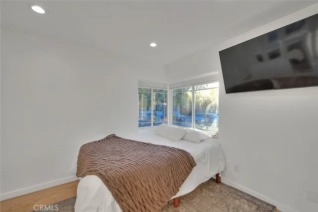 a bedroom with a large bed and a window