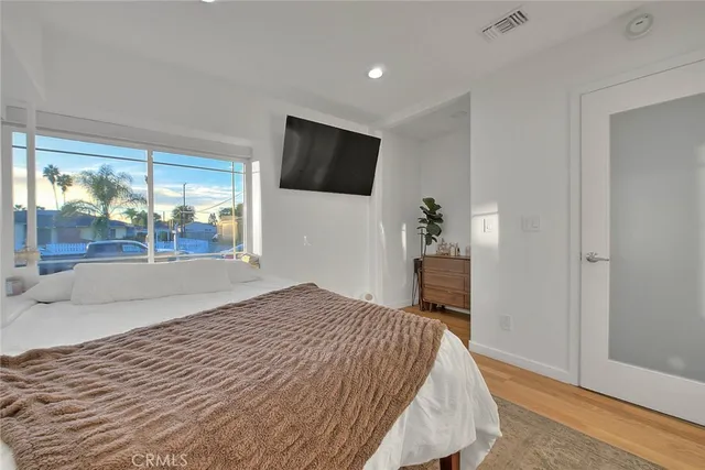 a bedroom with a bed and a large window