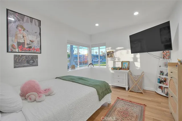 a bedroom with a bed and a flat screen tv