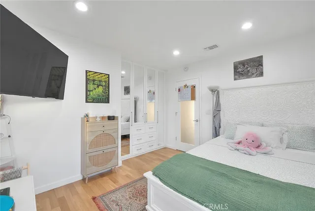 a bedroom with a bed and a television