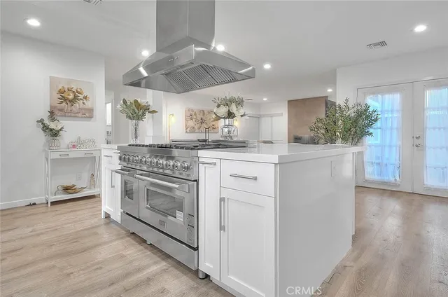 a kitchen with stainless steel appliances granite countertop a stove and a sink