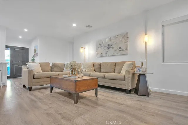 a living room with furniture and a painting on the wall