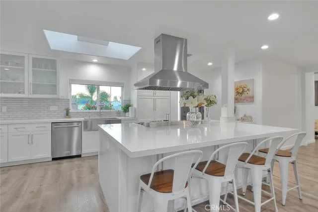a kitchen with stainless steel appliances granite countertop a sink and a stove