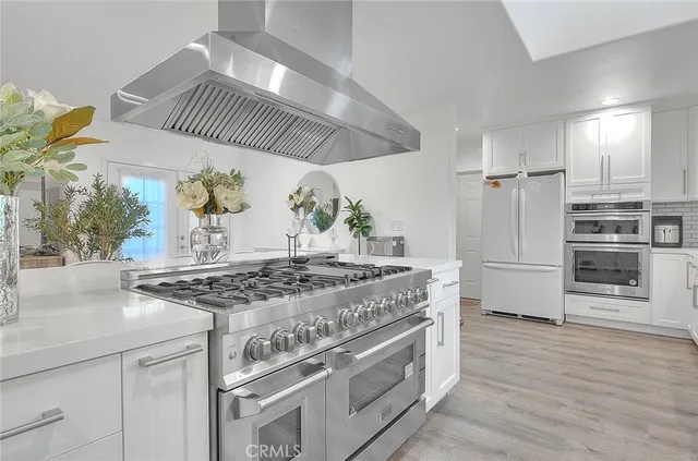 a kitchen with stainless steel appliances granite countertop a stove and a refrigerator