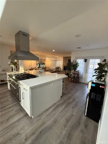 a kitchen with stainless steel appliances a sink a stove top oven a counter space and cabinets