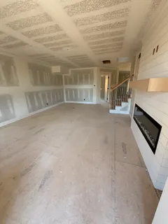 a view of a livingroom with an empty space and a window