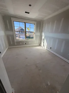 a view of empty room with a fireplace