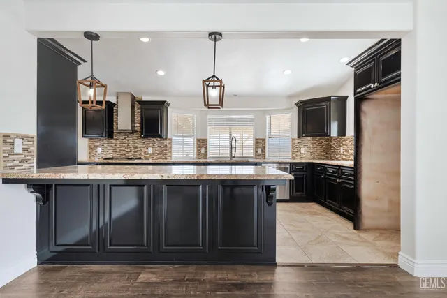 a kitchen with a sink refrigerator and microwave