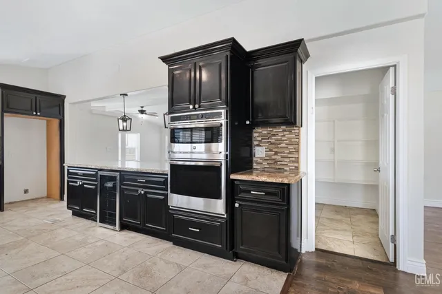 a kitchen with granite countertop a refrigerator and a stove