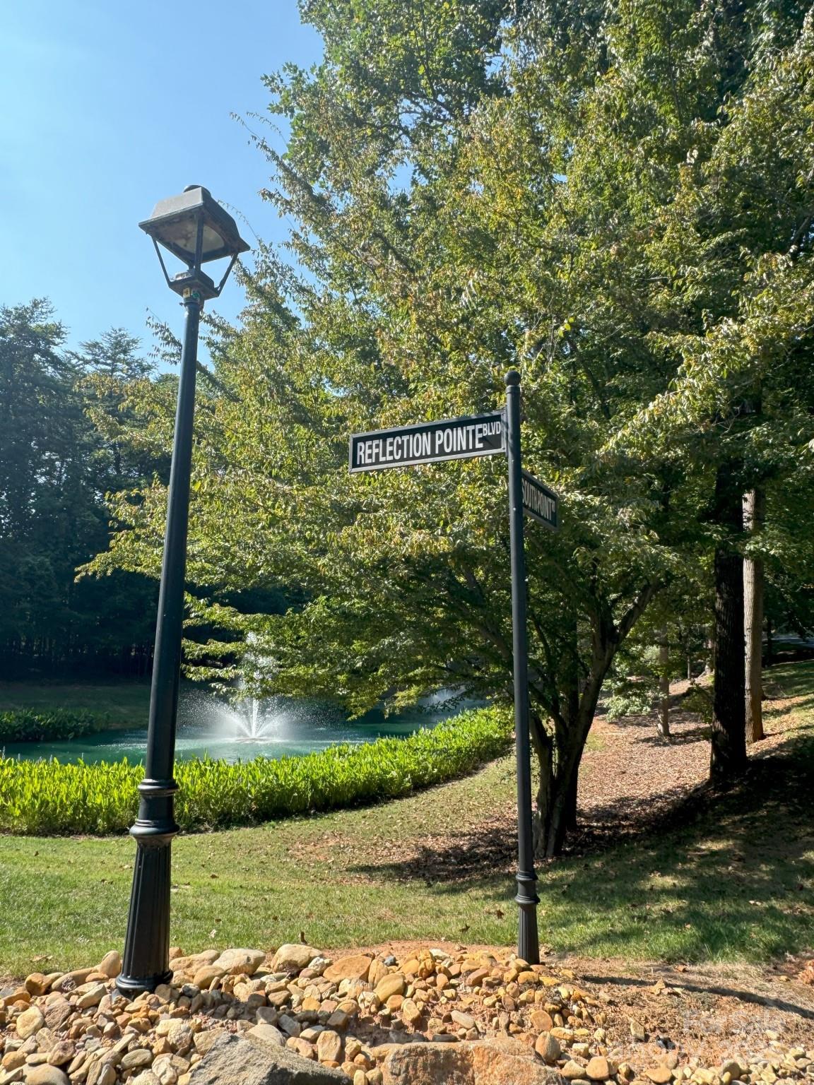1532 Reflection Pointe Boulevard Belmont, NC 28012 - Photo 12 of 20 a street sign on the side of the road