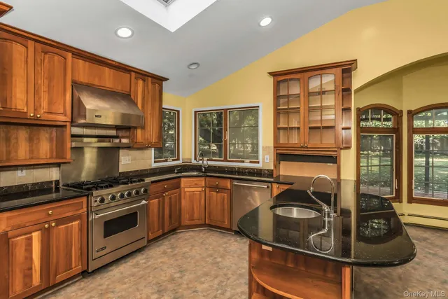 a view of a kitchen with a sink and large window