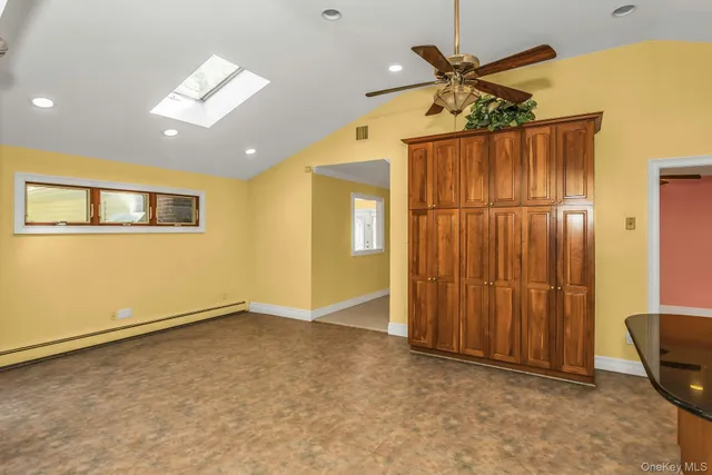 a view of an empty room with a kitchen