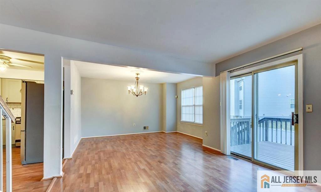 115 Salem Road North Brunswick, NJ 08902 - Photo 13 of 24 a view of an empty room with window and wooden floor