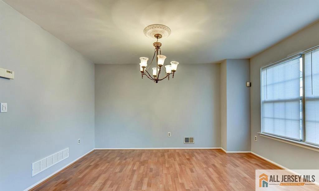 115 Salem Road North Brunswick, NJ 08902 - Photo 14 of 24 a view of a chandelier fan and wooden floor