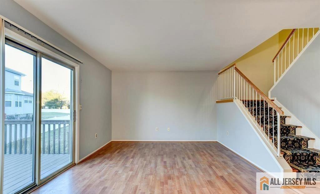 115 Salem Road North Brunswick, NJ 08902 - Photo 15 of 24 a view of a hallway with wooden floor and staircase