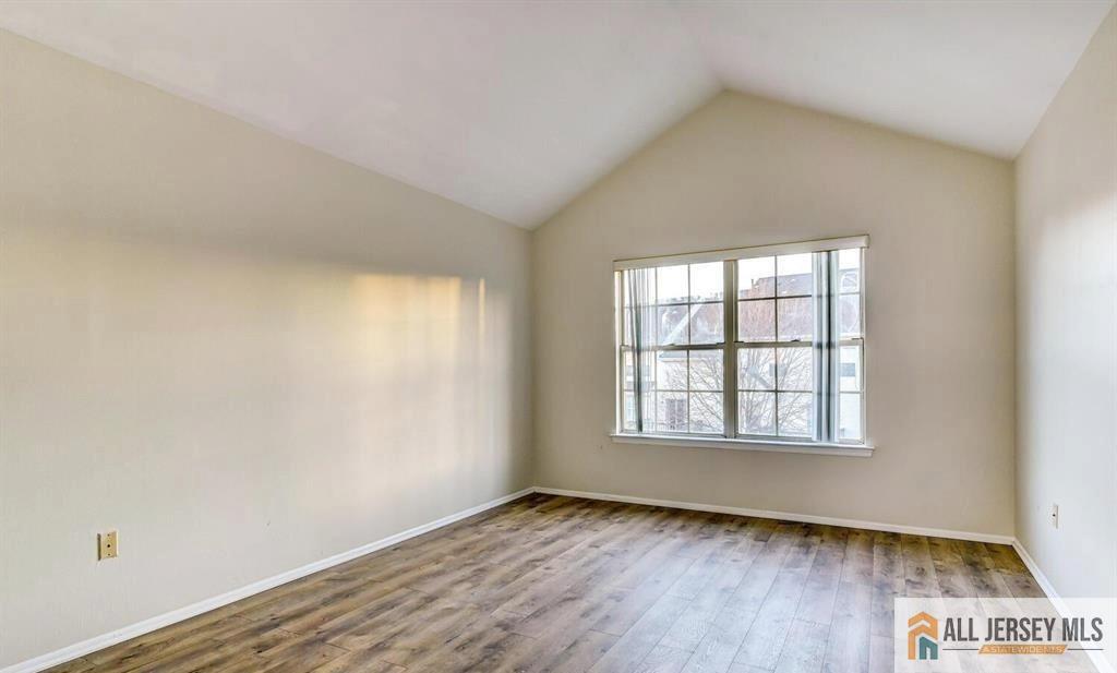 115 Salem Road North Brunswick, NJ 08902 - Photo 18 of 24 an empty room with wooden floor and windows