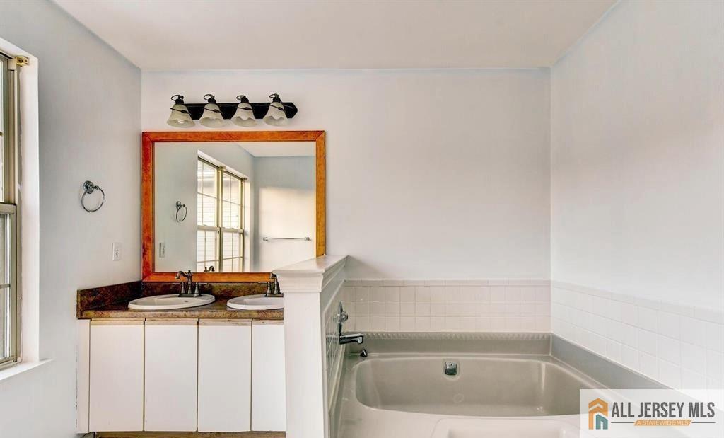 115 Salem Road North Brunswick, NJ 08902 - Photo 19 of 24 a bathroom with a sink a toilet and a window