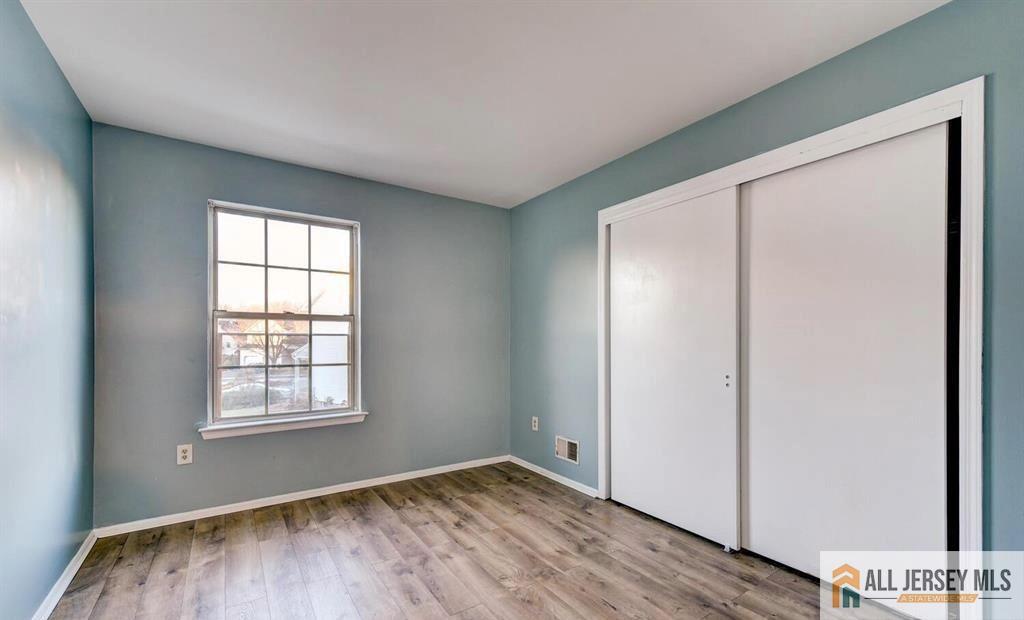 115 Salem Road North Brunswick, NJ 08902 - Photo 21 of 24 an empty room with wooden floor and windows