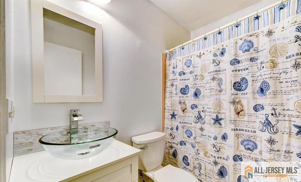 115 Salem Road North Brunswick, NJ 08902 - Photo 22 of 24 a bathroom with a sink and a mirror
